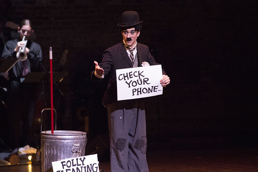 A Folly Theater performer invites the audience to check their phones during the original campaign.